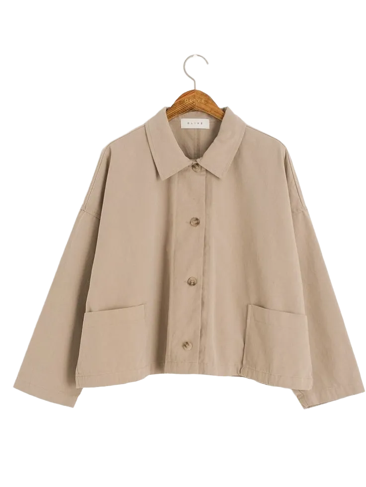 A row of premium wool coats and blazers freshly dry cleaned and hanging