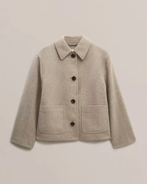 Winter coats and jackets hanging ready for professional dry cleaning service