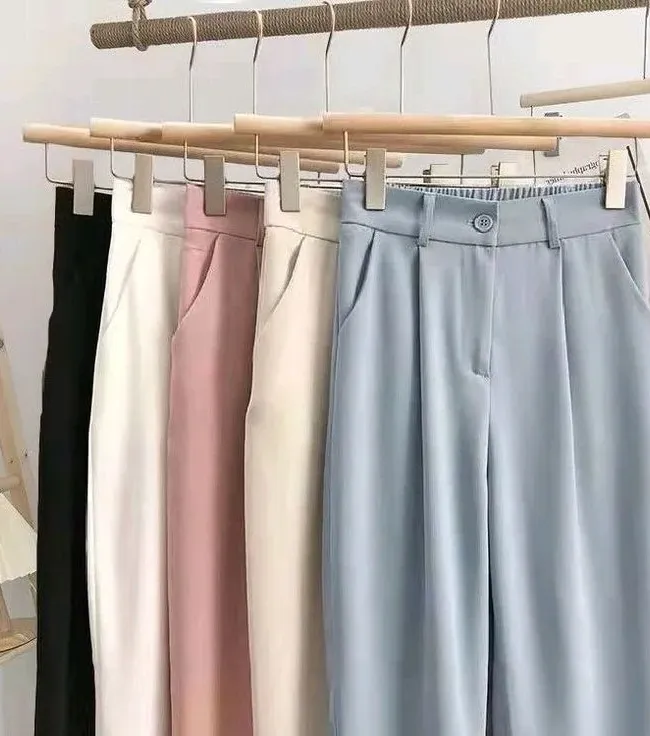 Perfectly creased formal trousers hanging cleanly