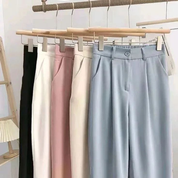 Perfectly creased formal trousers hanging cleanly